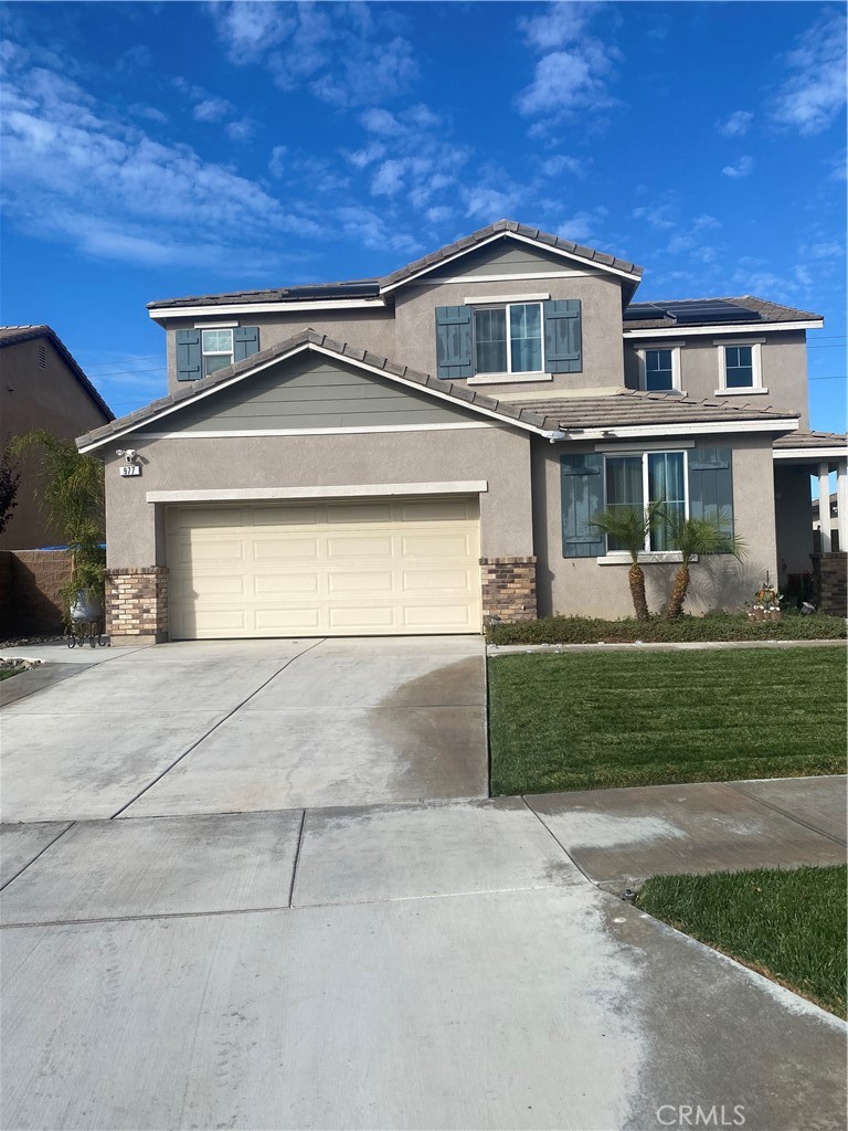 a front view of a house with a yard and garage