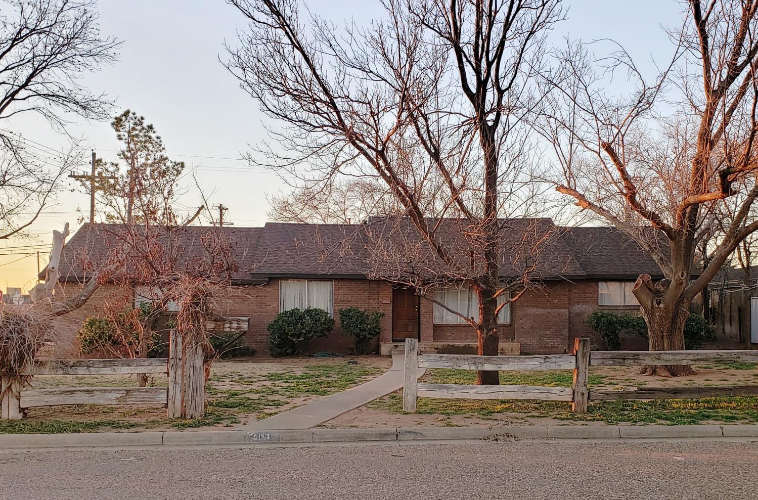 a house that has a tree in front of it