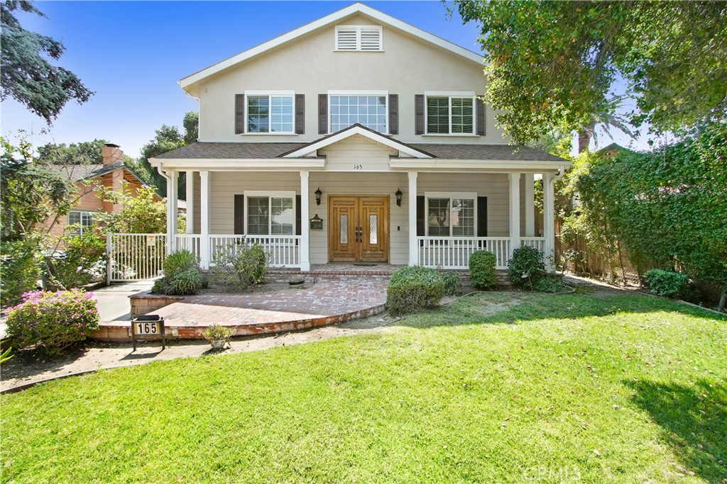 a front view of a house with a yard and porch