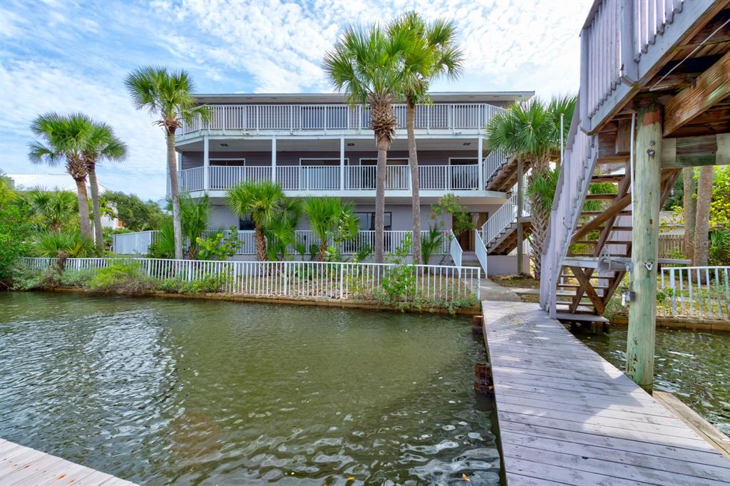 a view of swimming pool with outdoor seating and lake view