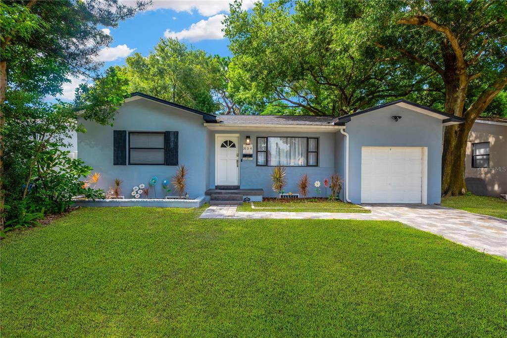 a front view of house with yard and outdoor seating