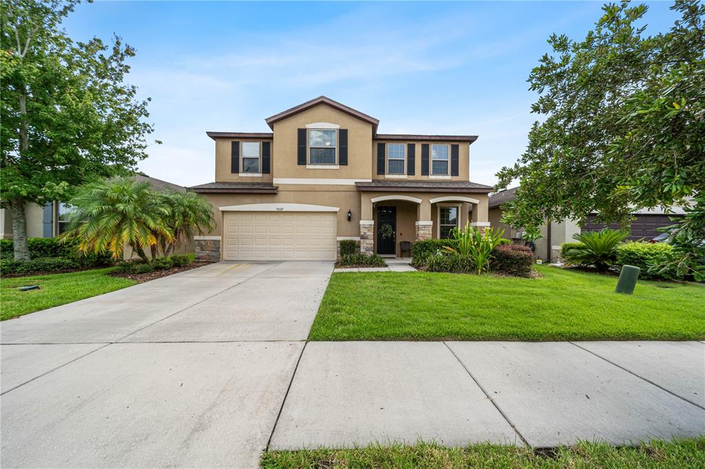 a front view of a house with a yard