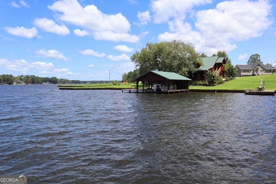 a view of a lake with houses in back