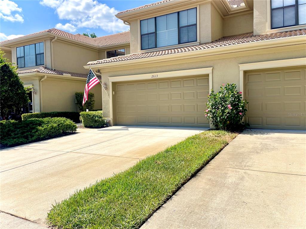 a front view of a house with a yard and garage