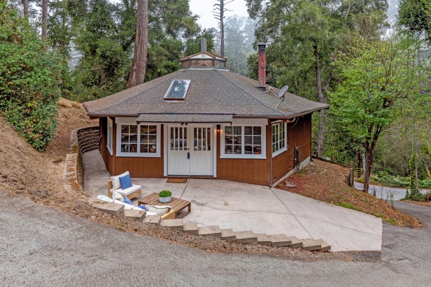 a backyard of a house with table and chairs