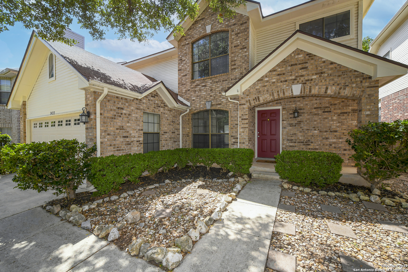 a front view of a house with garden