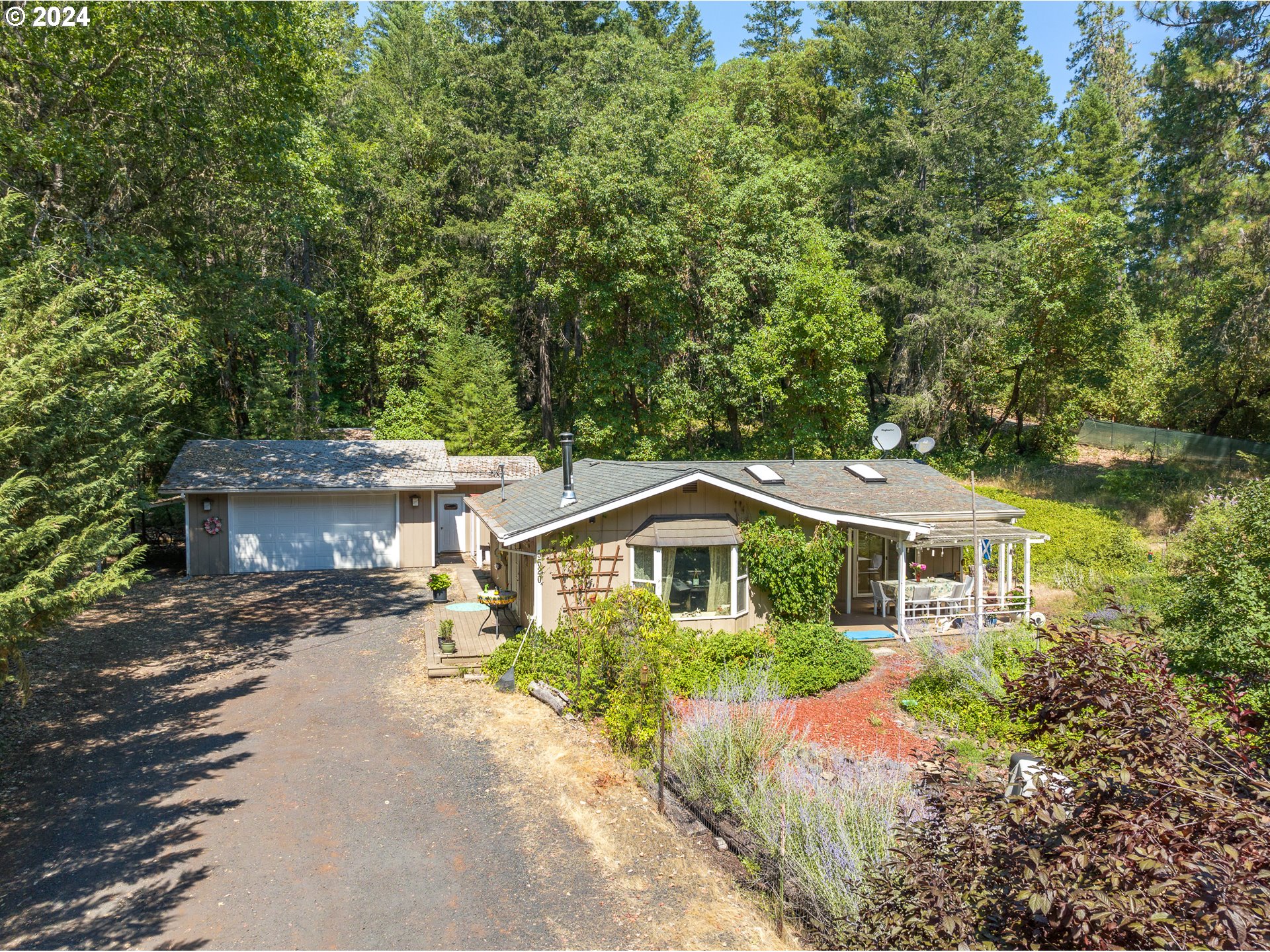 a front view of a house with a yard and trees