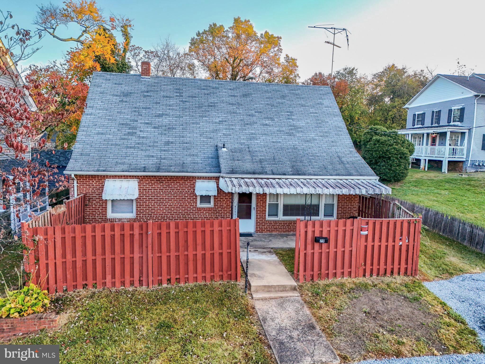 a view of a house with wooden deck front of house