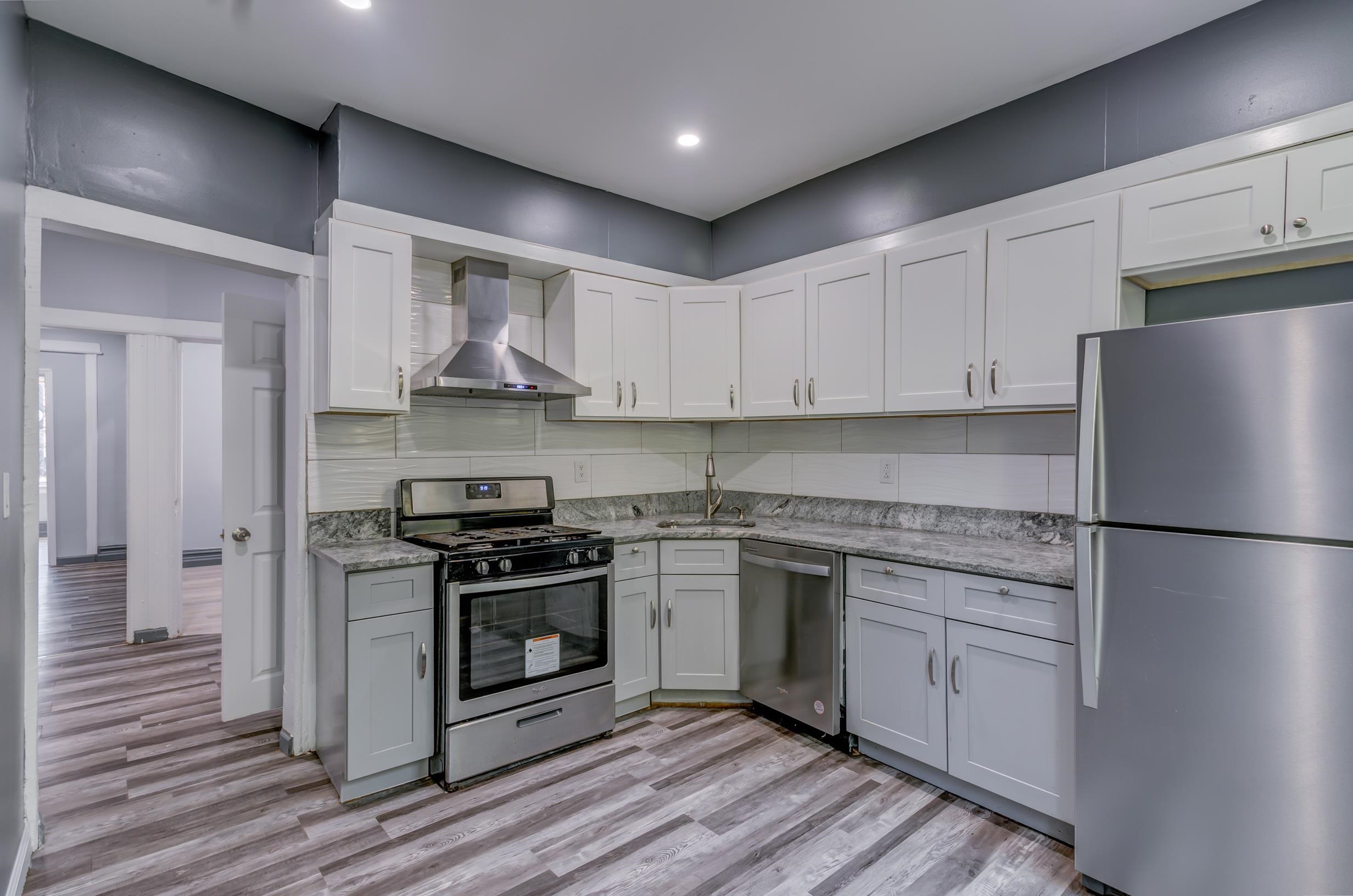 a kitchen with a stove sink and refrigerator