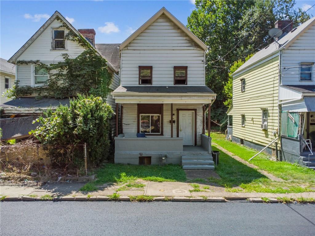 a front view of house with yard and green space