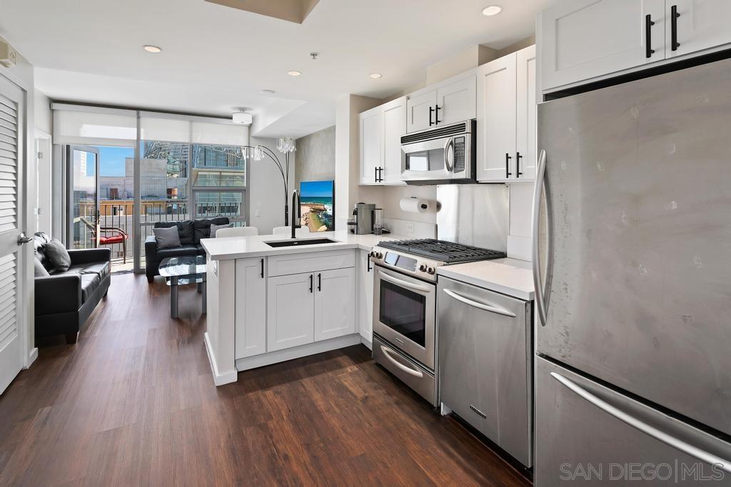 a kitchen with white cabinets stainless steel appliances and sink