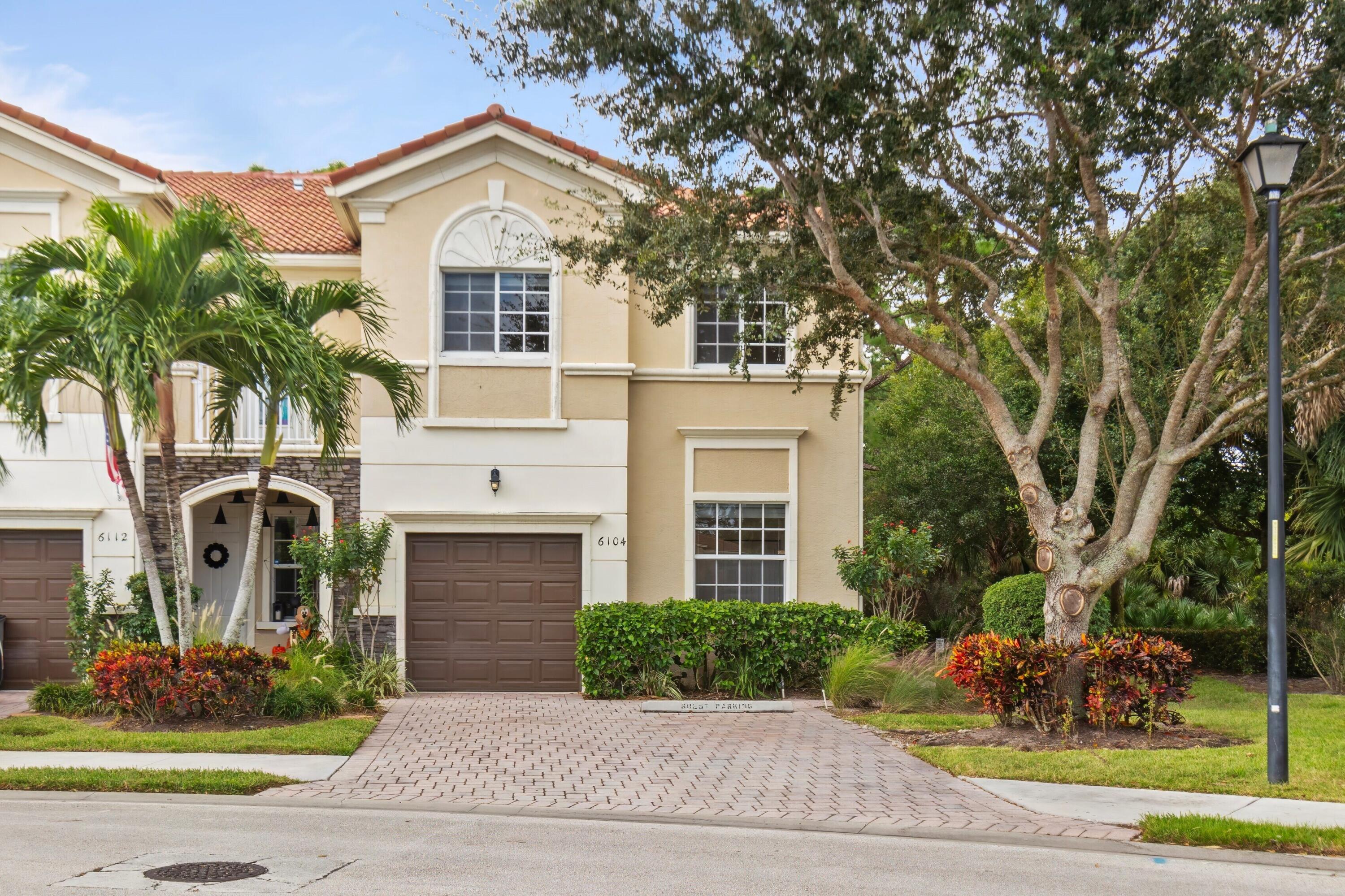 a front view of a house with yard and trees