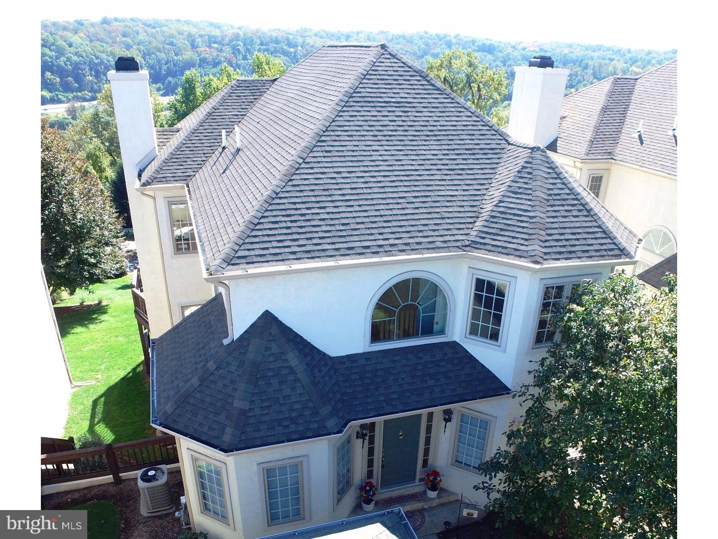 a aerial view of a house with a yard and potted plants