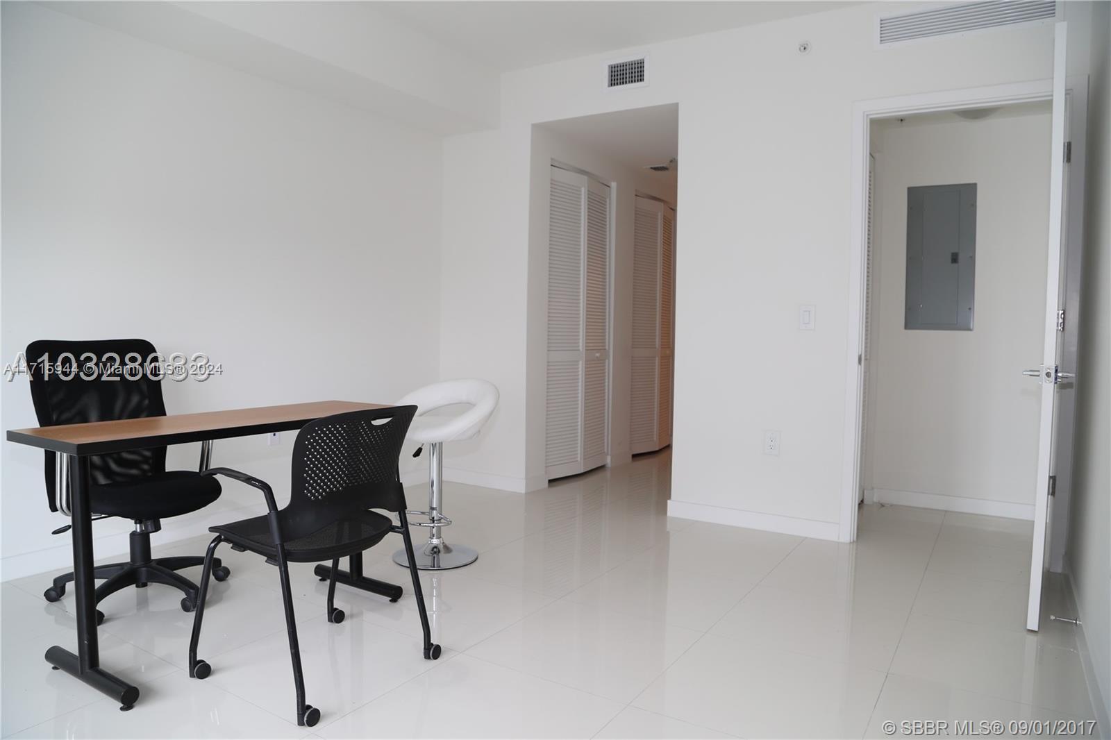 a view of a livingroom with furniture and a window