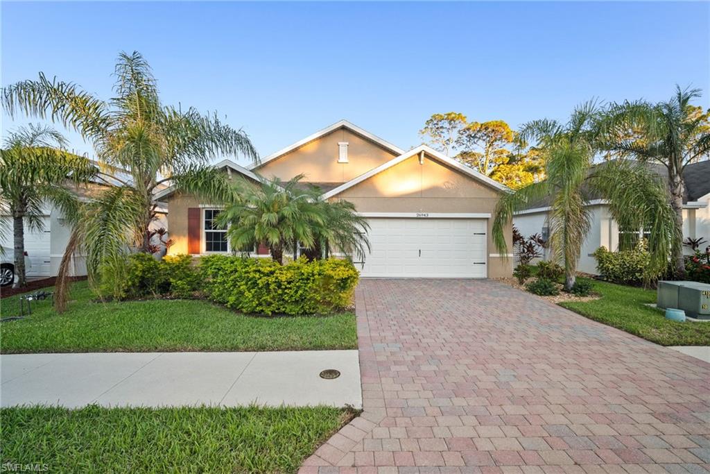 View of front of property with a front yard and a garage