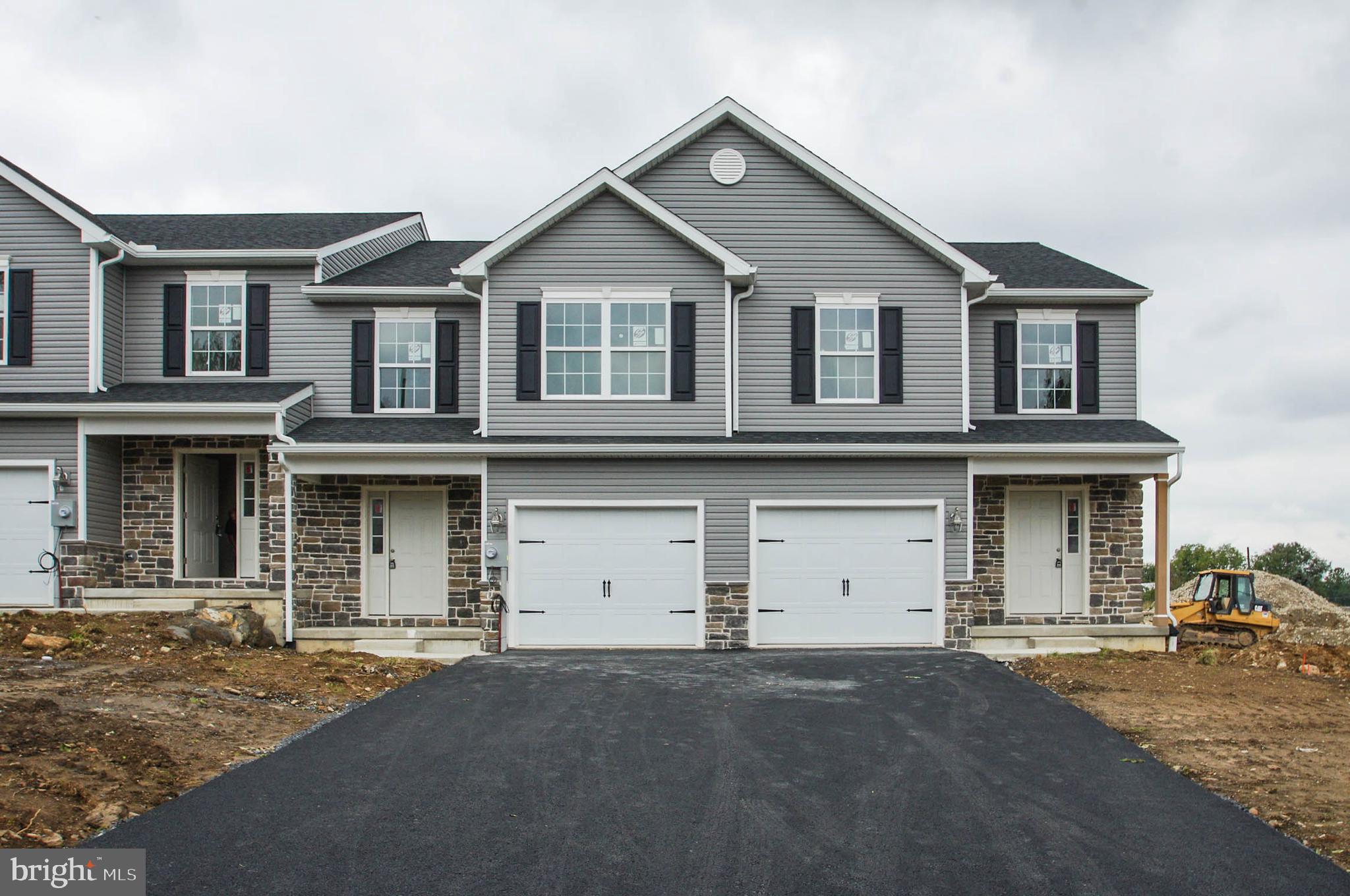 a front view of a house with a garage