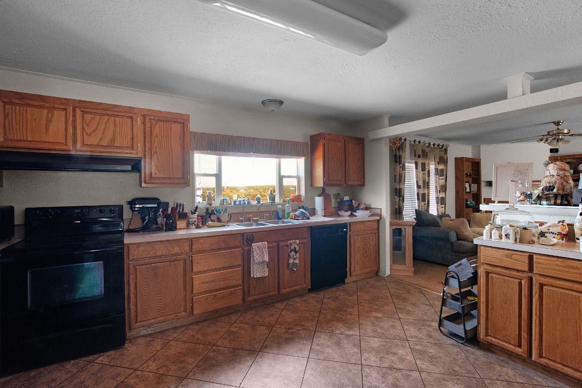 a kitchen with stainless steel appliances granite countertop a stove sink and cabinets