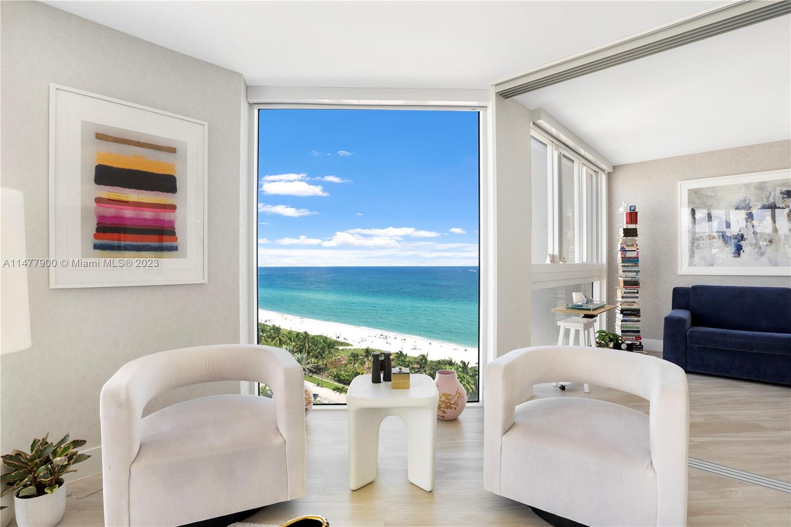 a living room with furniture and floor to ceiling window