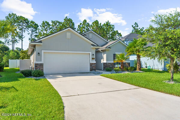 a front view of house with yard and green space