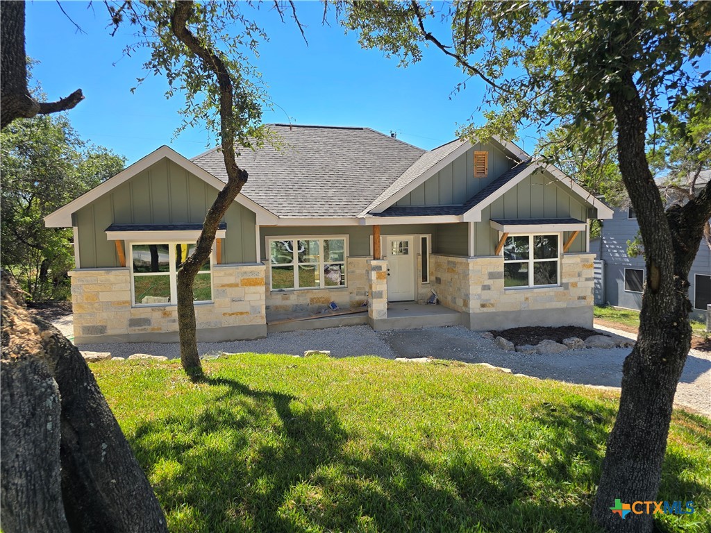 a front view of a house with yard patio and green space