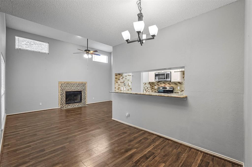 a view of a livingroom with wooden floor a fireplace and window