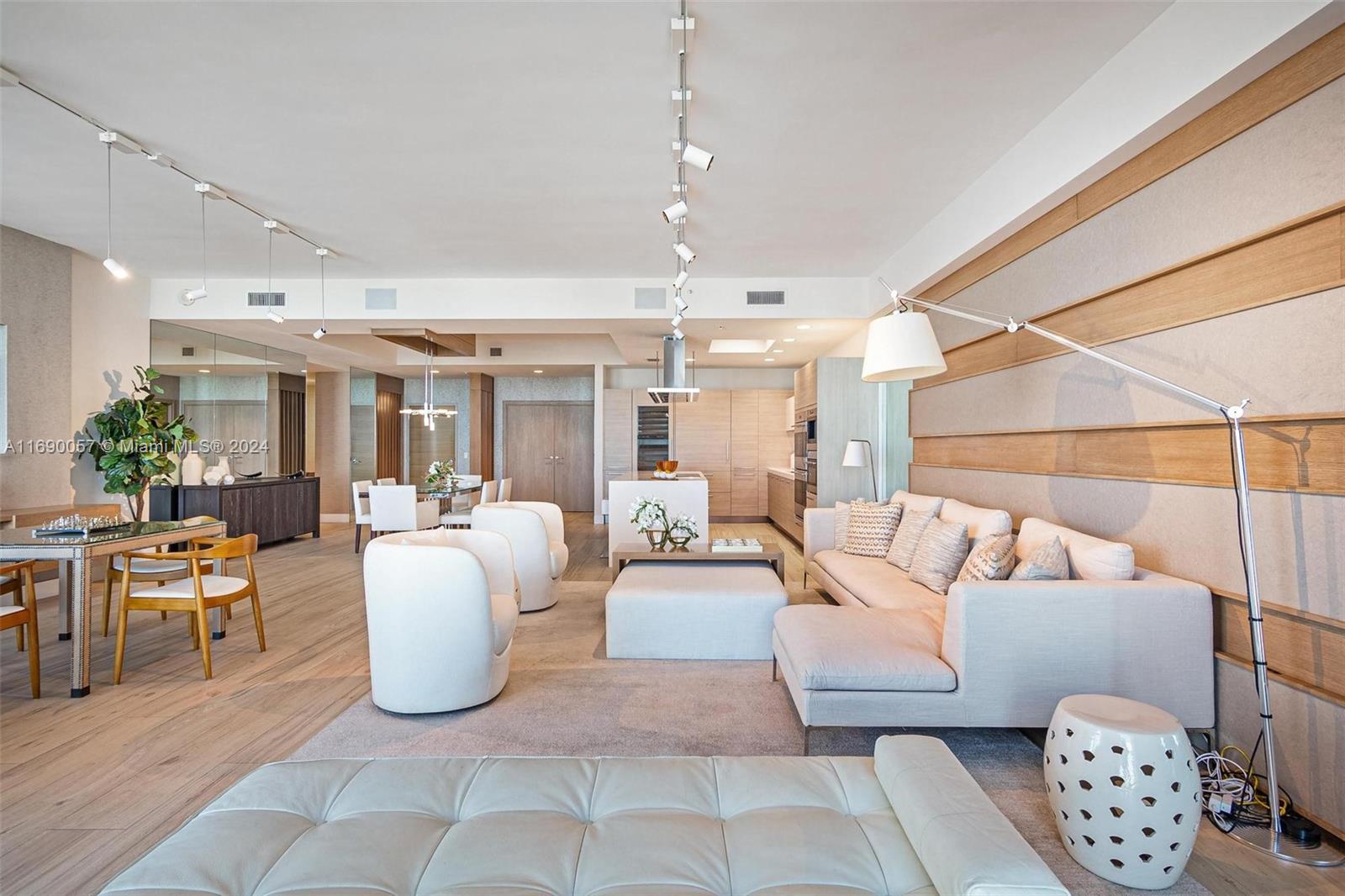 a living room with furniture a chandelier and a rug