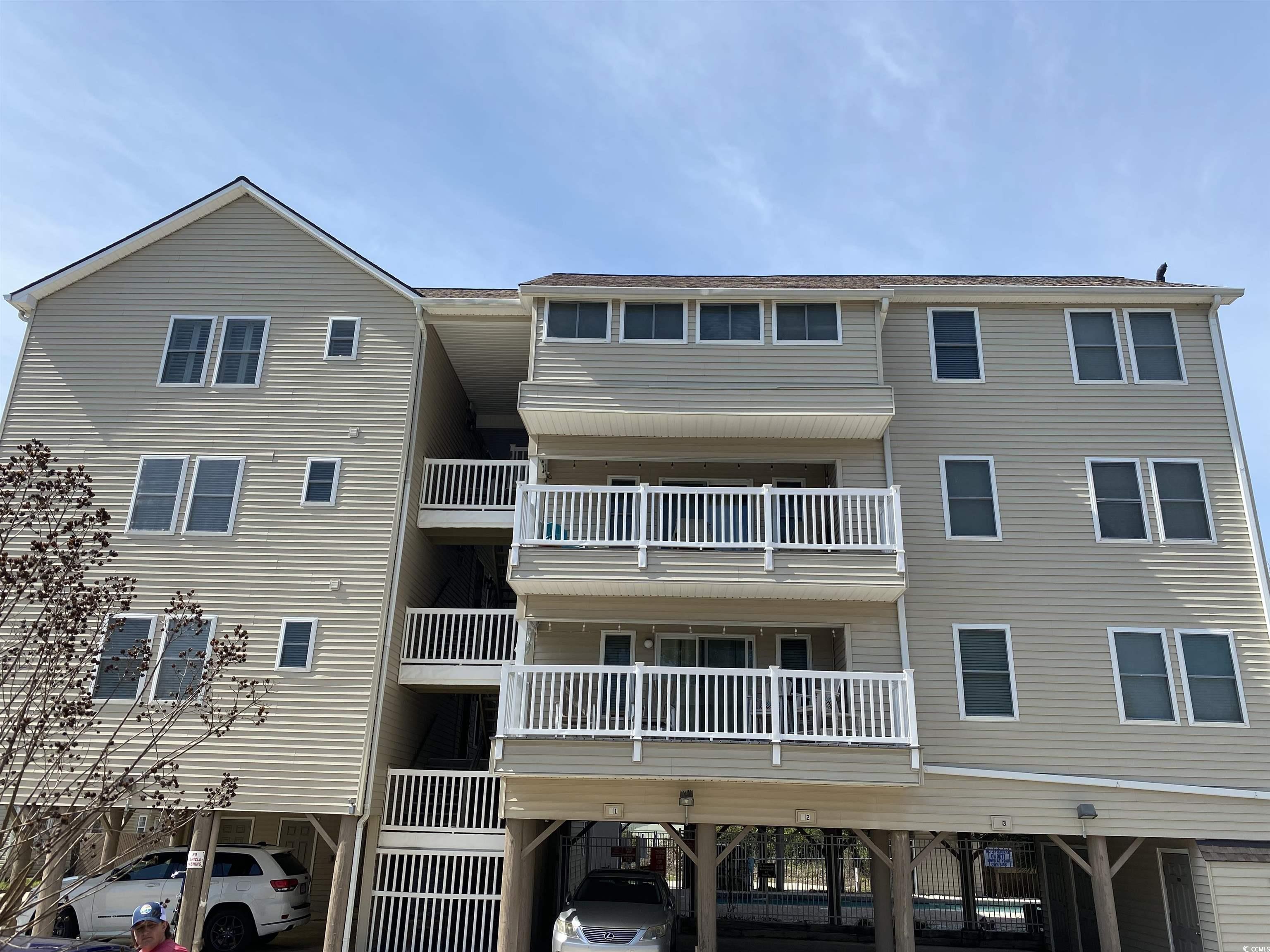 View of building exterior featuring a carport