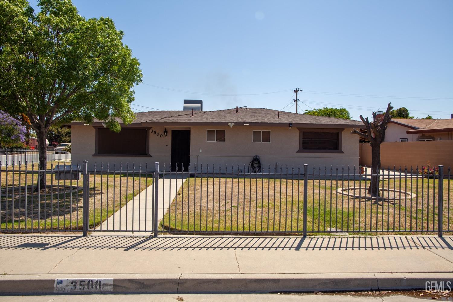 a front view of a house with a iron fence