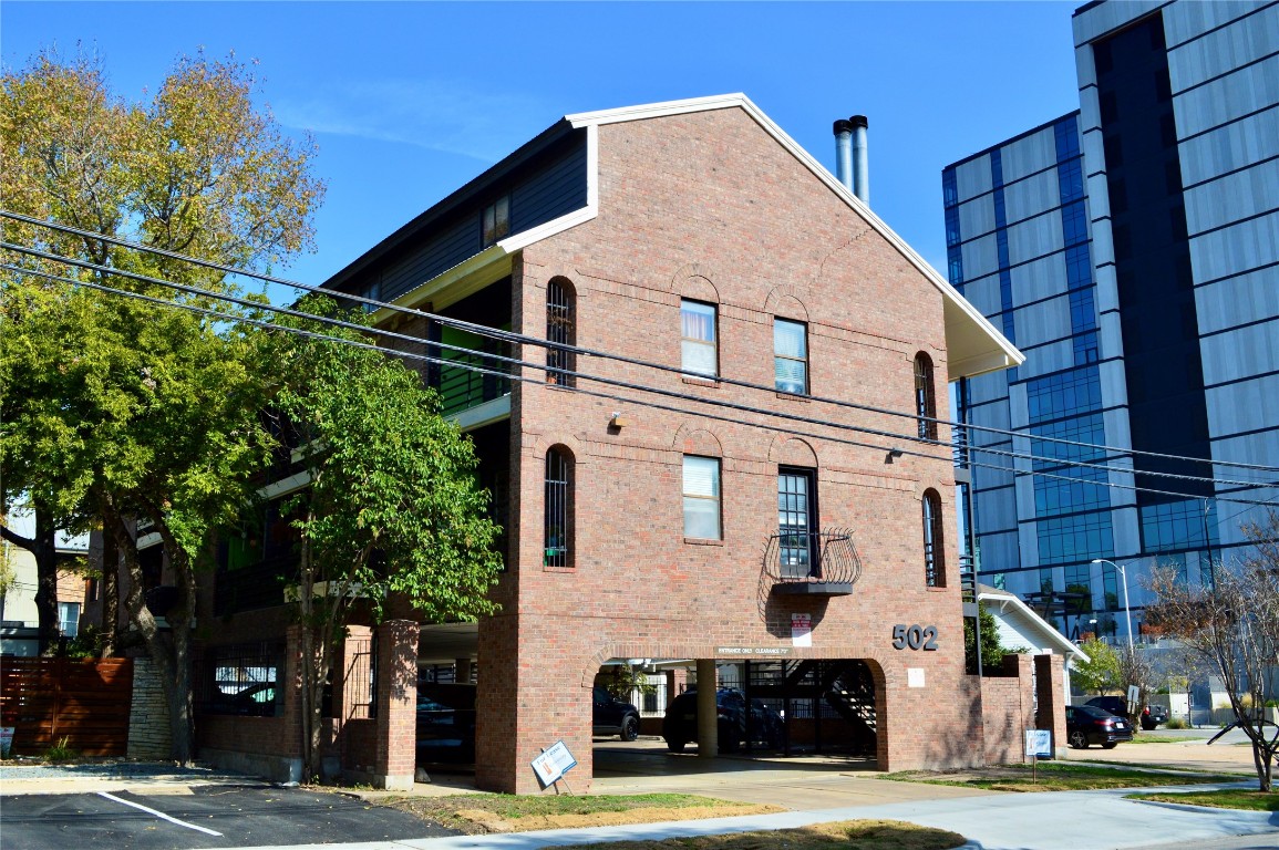 a front view of a building with a garden