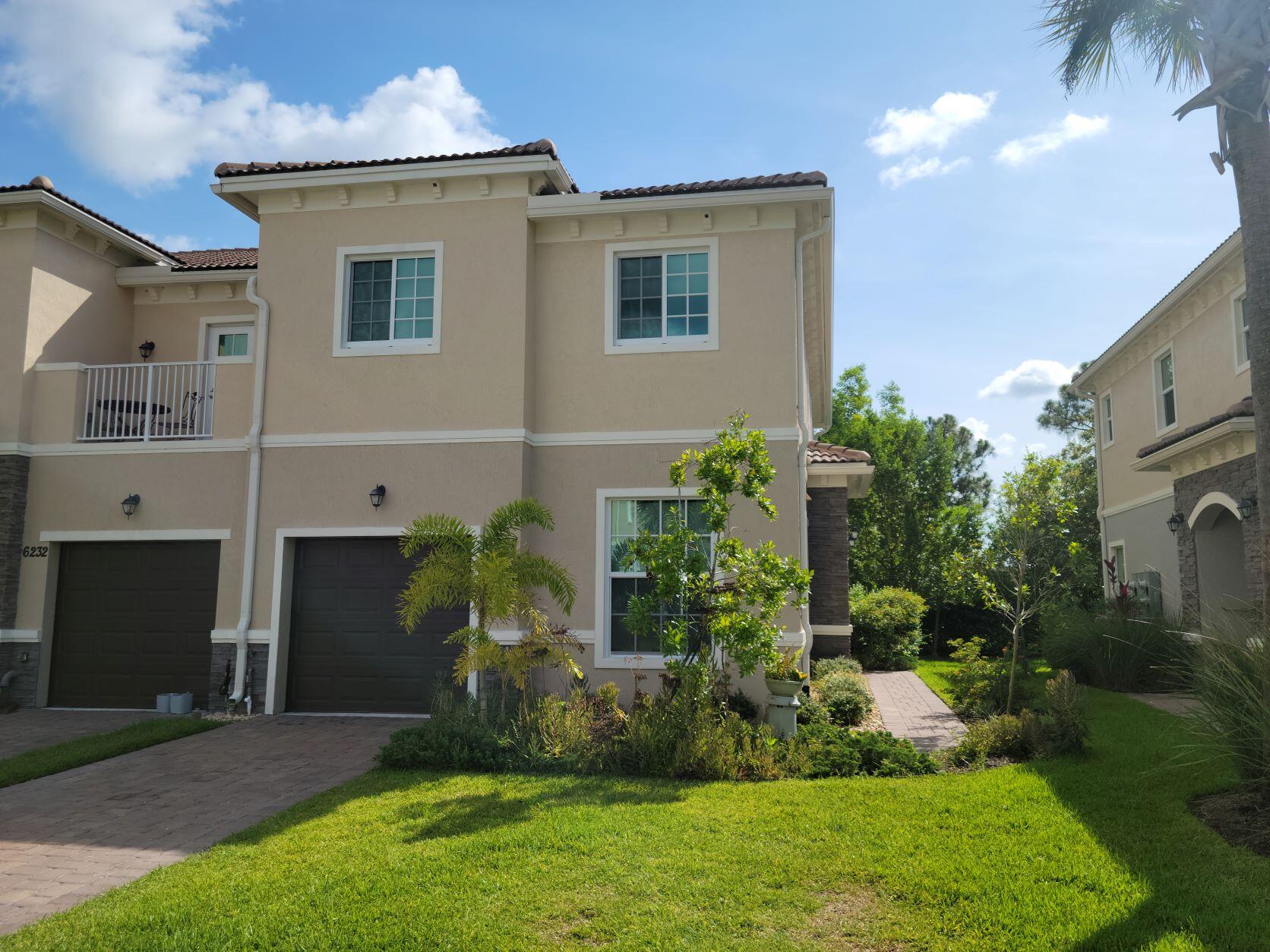 a front view of a house with a garden