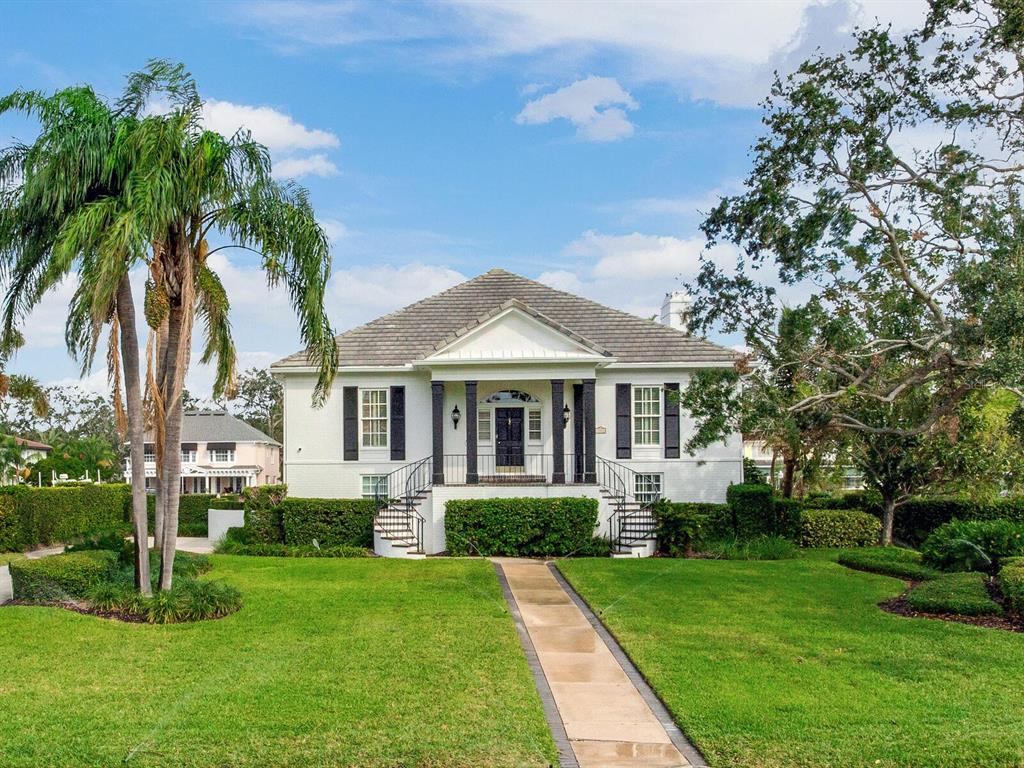 a front view of a house with a garden