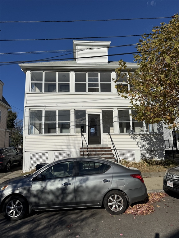 a front view of a house with parking space