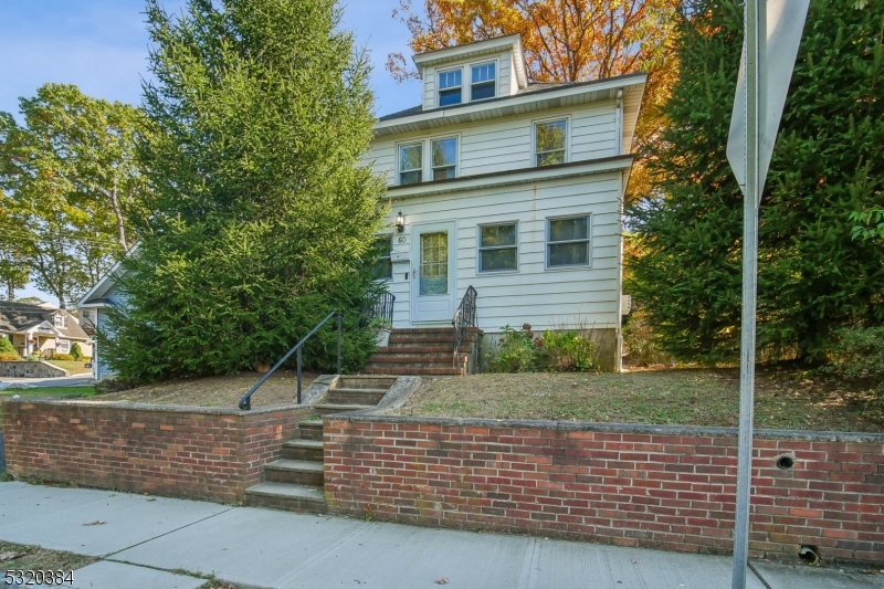 a view of a brick house with a yard