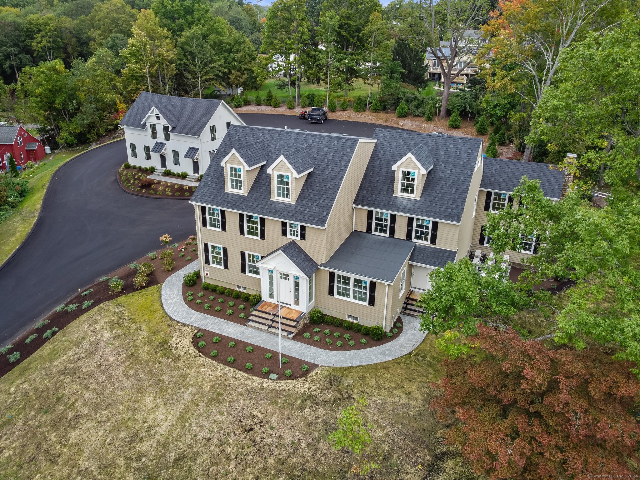 an aerial view of a house with garden space and street view