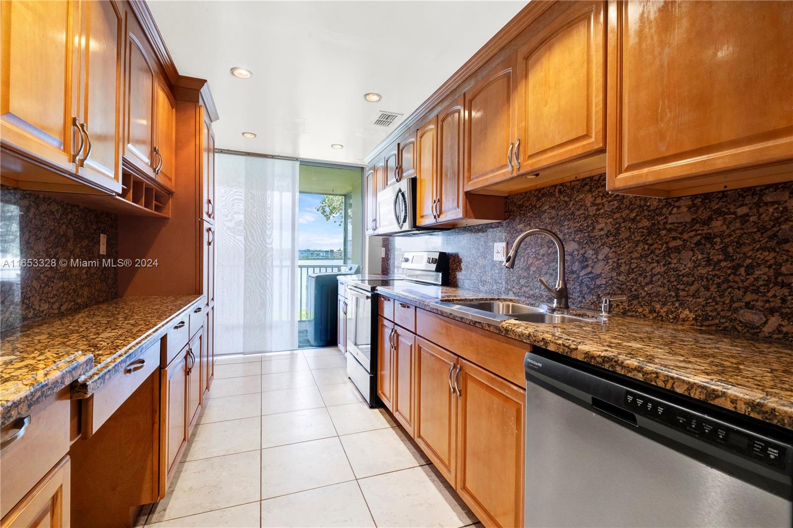 a kitchen with stainless steel appliances granite countertop a stove and a refrigerator