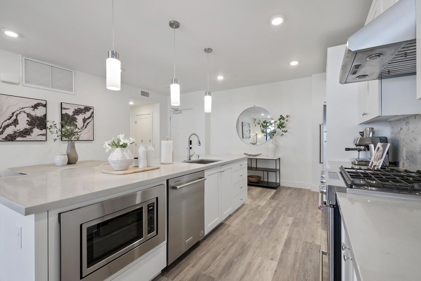 a kitchen with a sink stove and cabinets