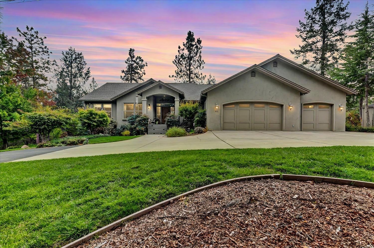 a front view of a house with a garden