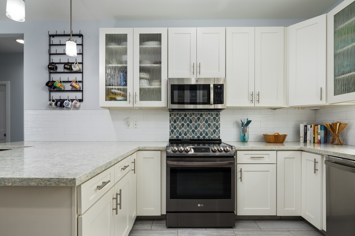 a kitchen with cabinets appliances and a window