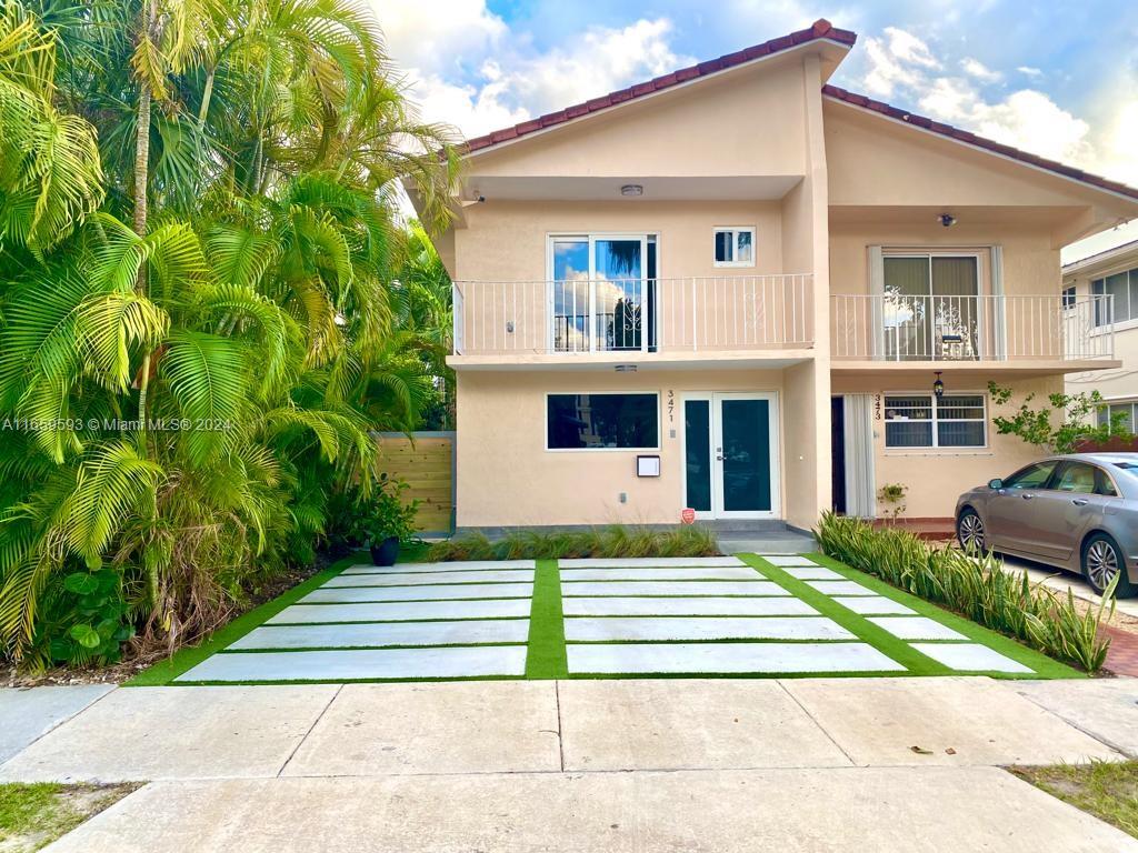 a view of a house with a yard