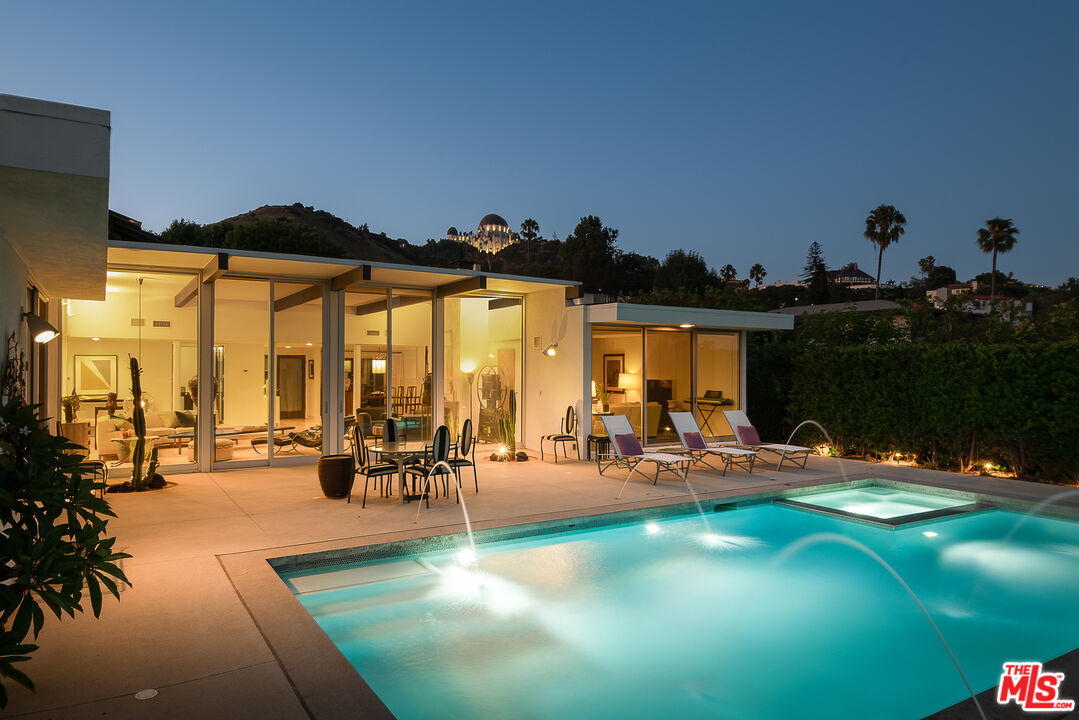 a view of a swimming pool and lounge chairs