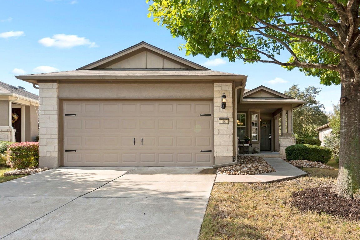 Beautiful tree graces the front yard of this Gray Myst model at 104 Huntsville Cove