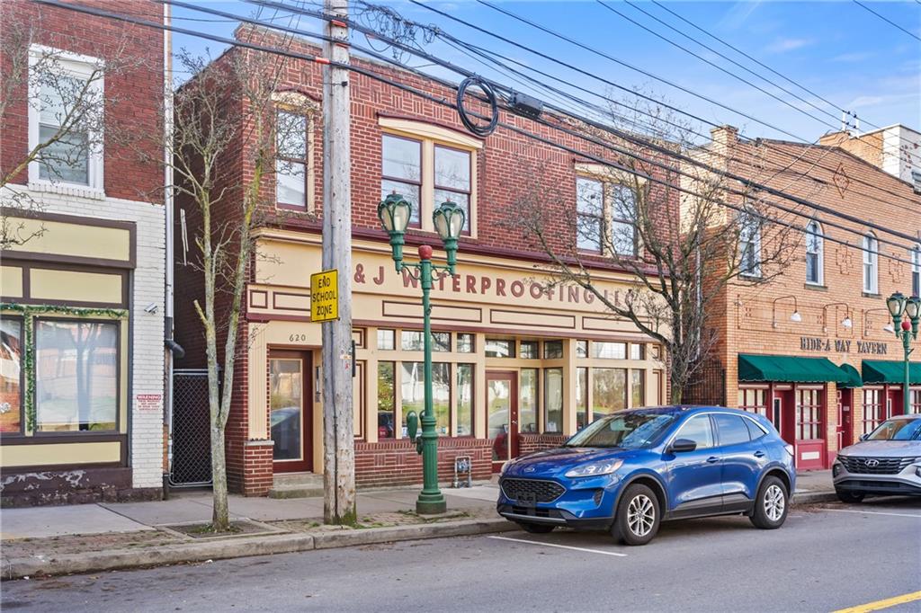 a view of a car parked in front of a building