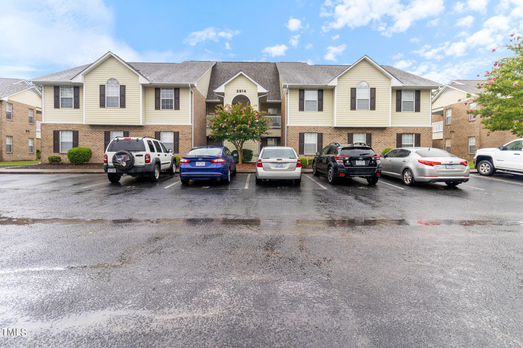 a view of cars parked in front of a house