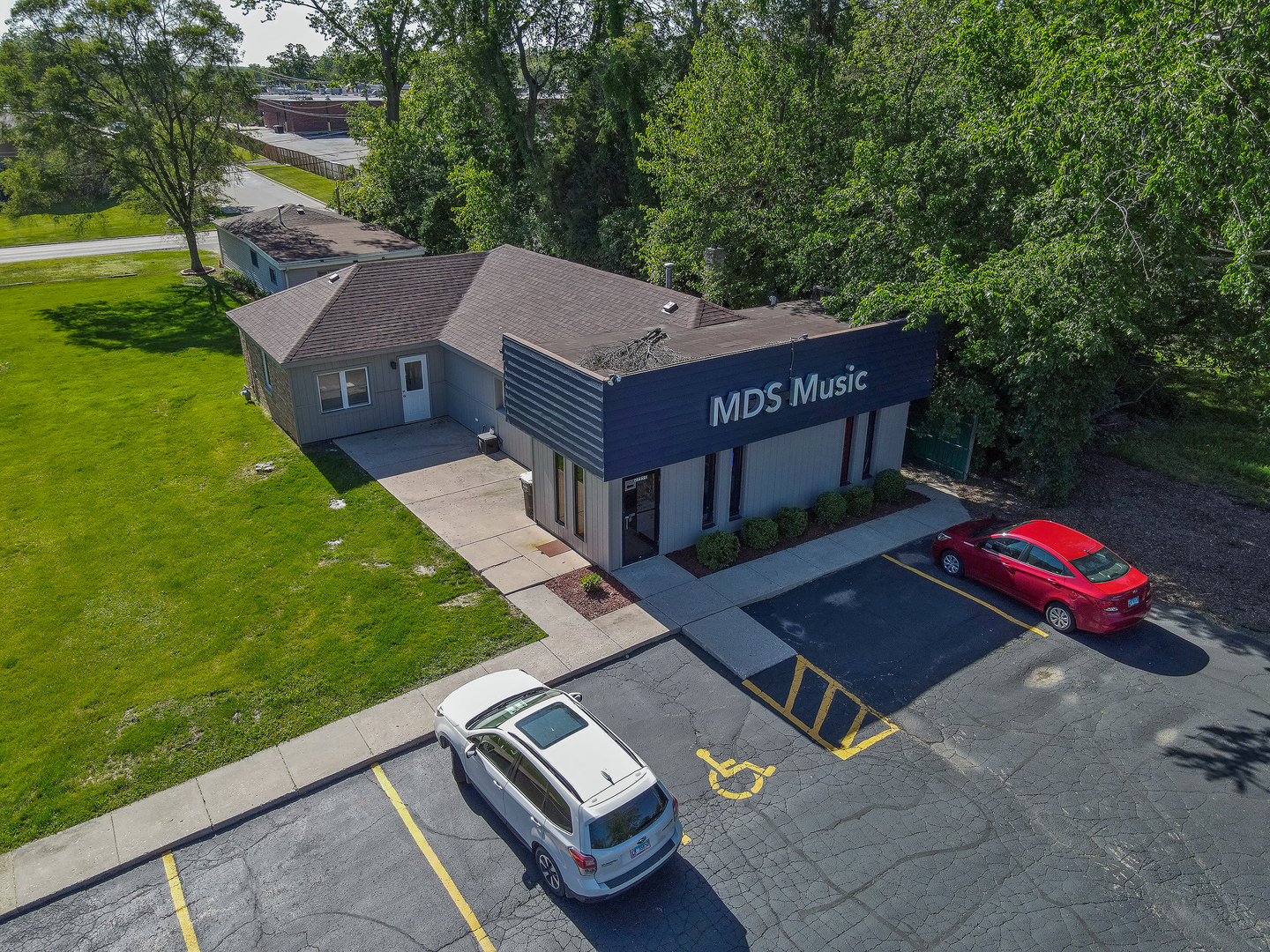 an aerial view of a house with backyard space and balcony