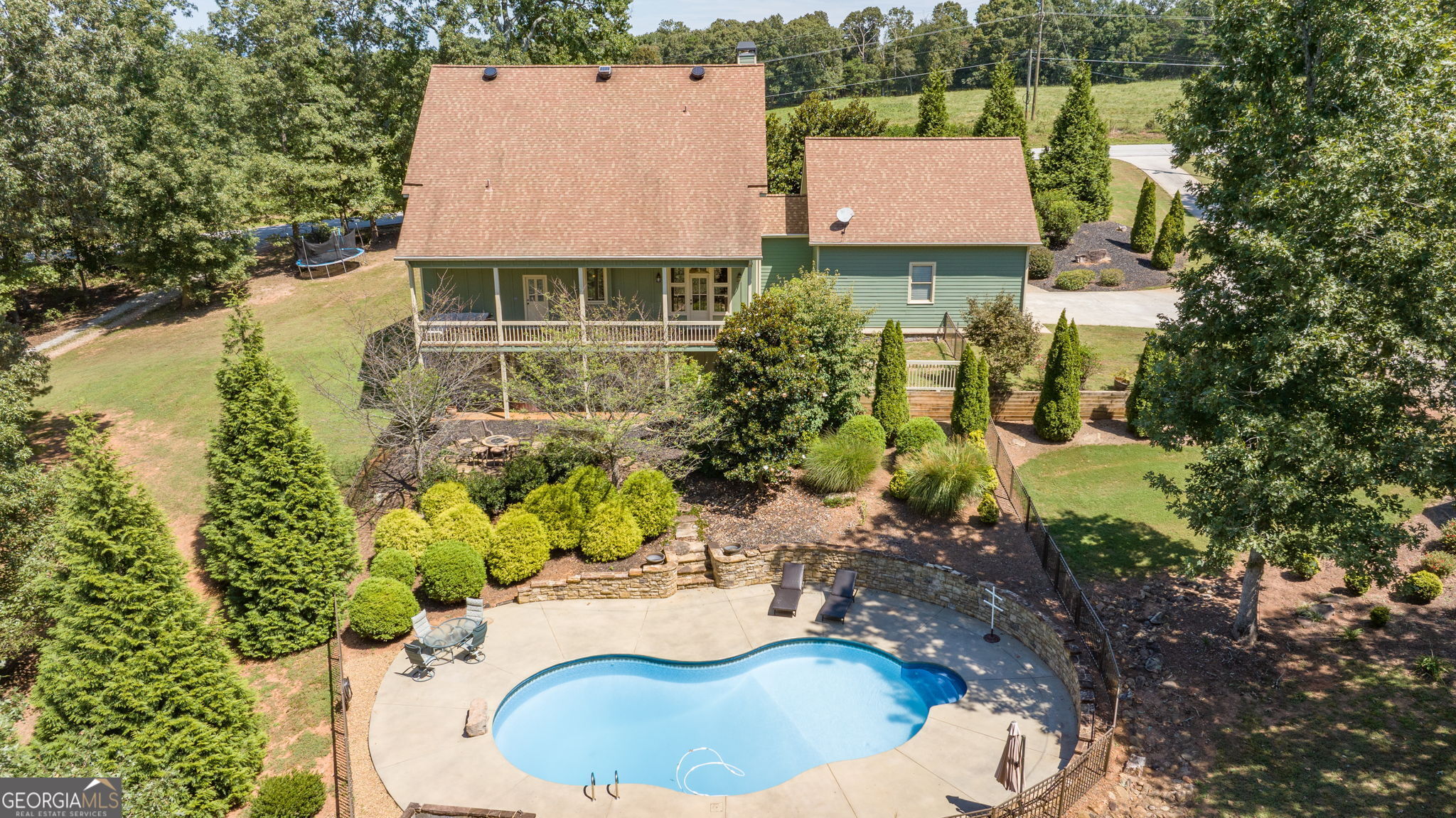 an aerial view of a house with a swimming pool