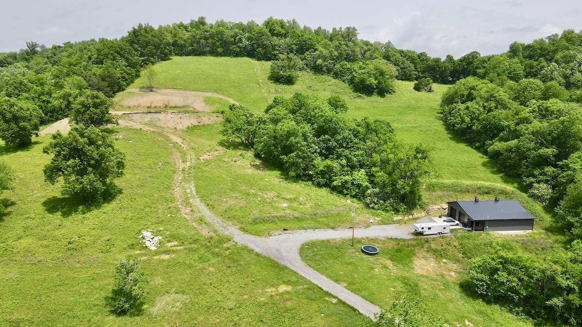 40x60 Shop with attached living quarters measuring 50x12.  41 Acres with leveled building site!  3 BR septic system installed.