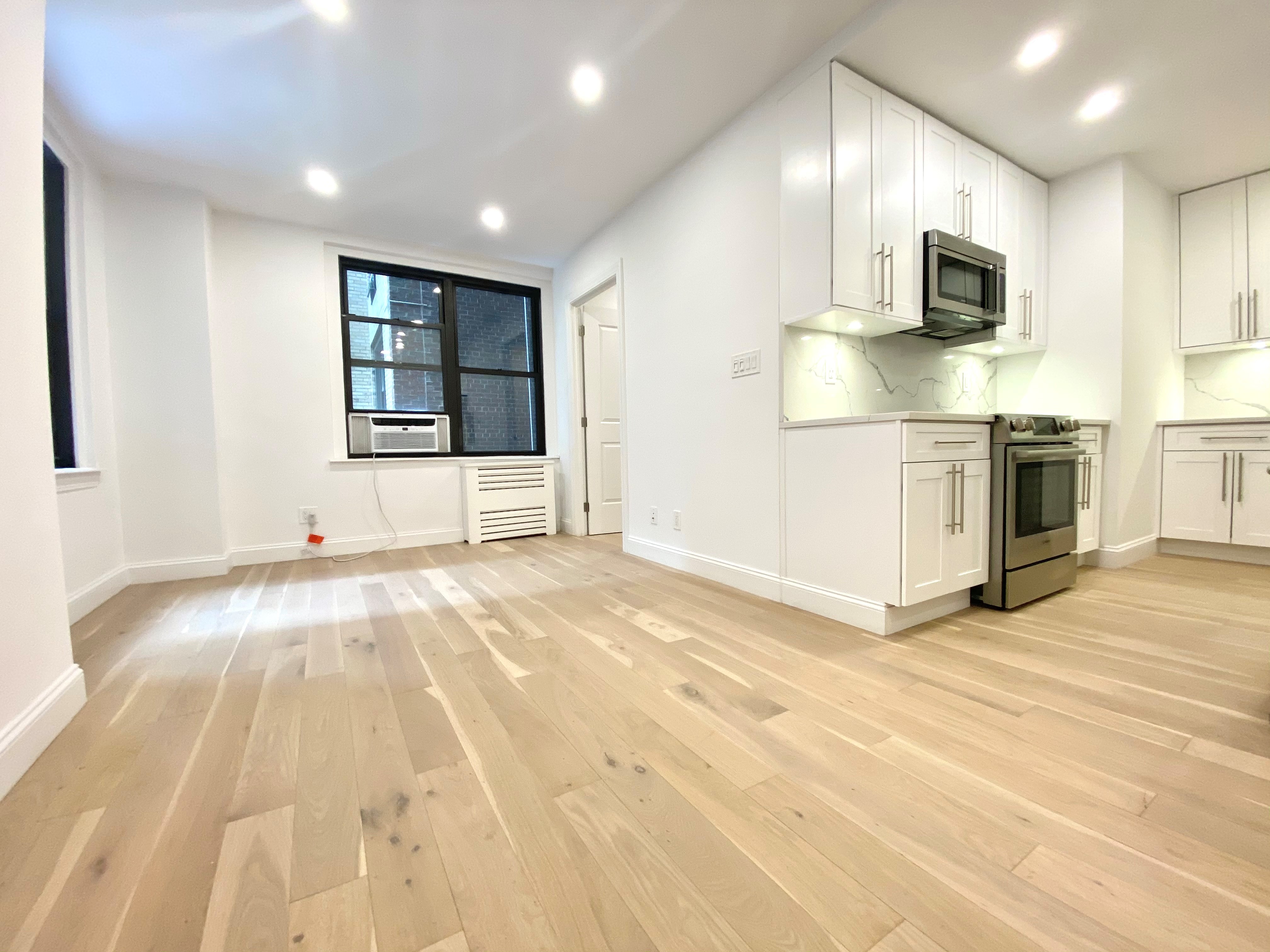 a view of a kitchen with a sink and a microwave