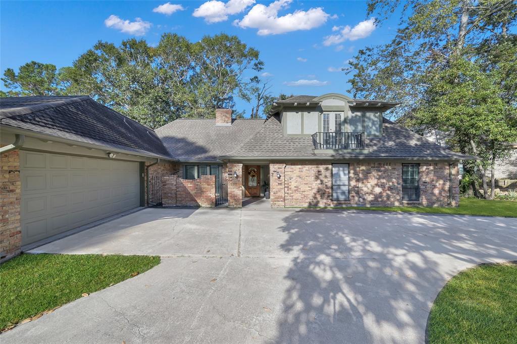 a view of a house with a patio and a yard