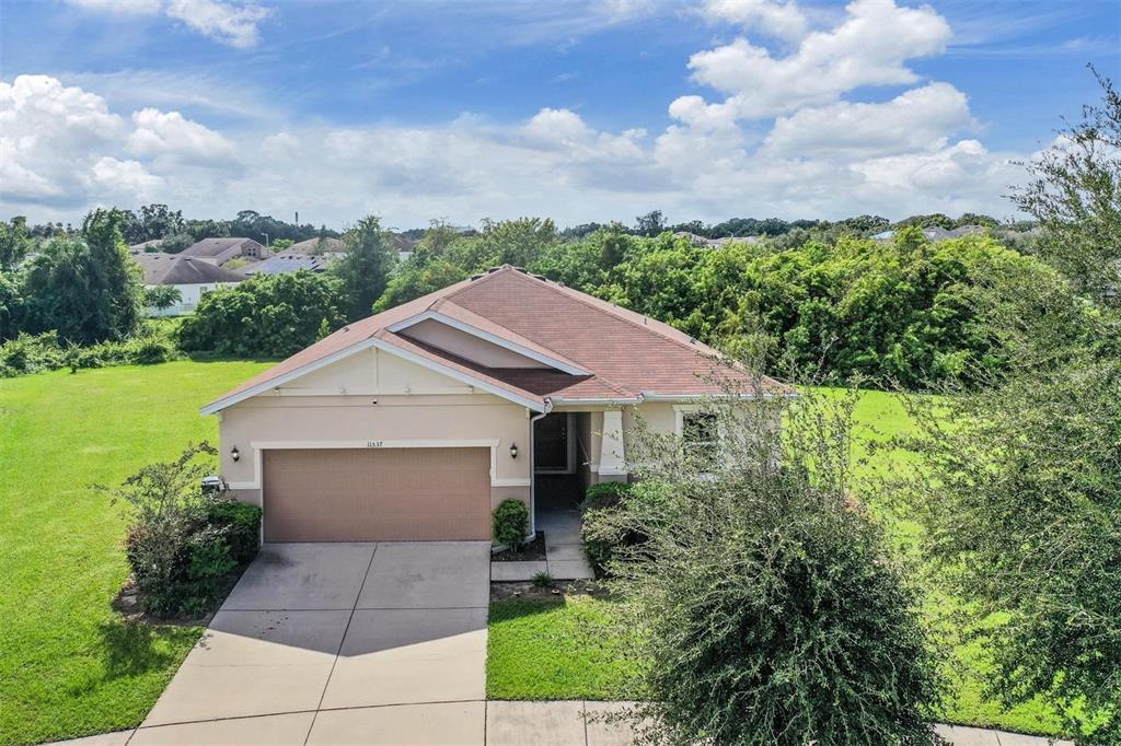 a house with green field in front of it