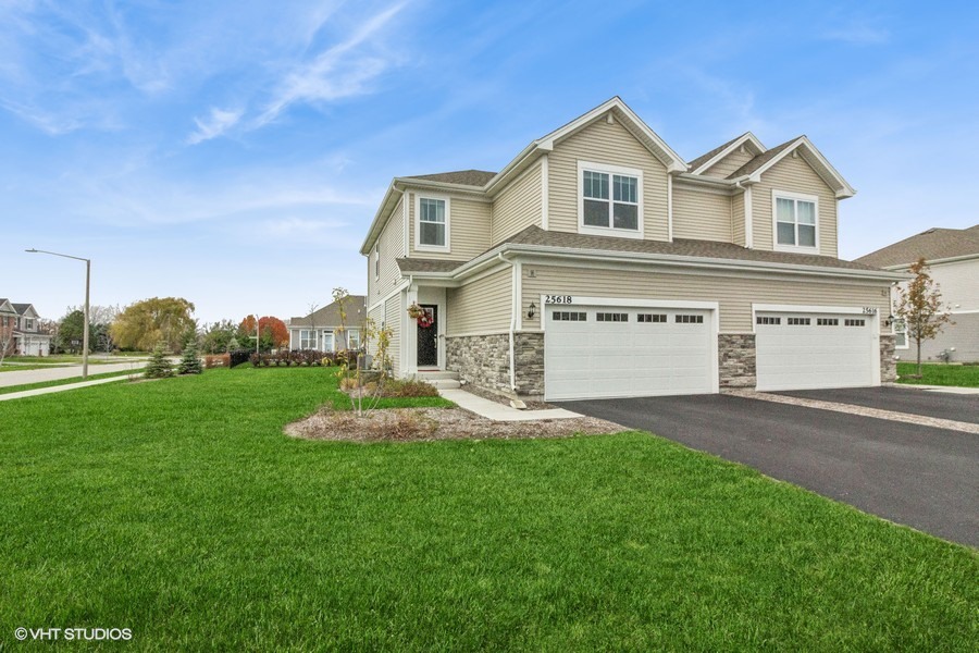 a front view of a house with a yard and garage